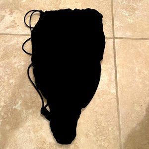 A bodysuit with an open back with straps